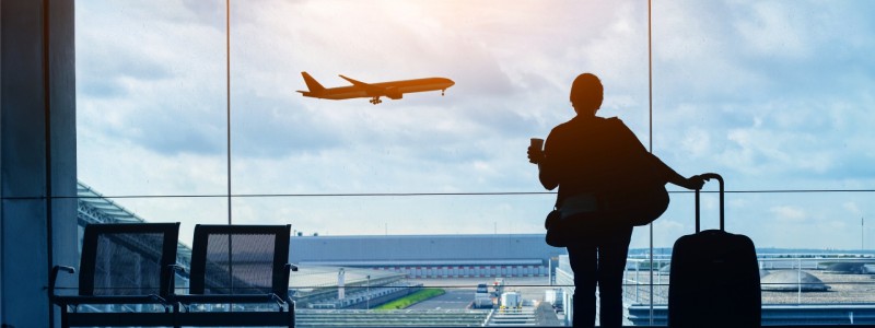 A person at the airport looking out the window