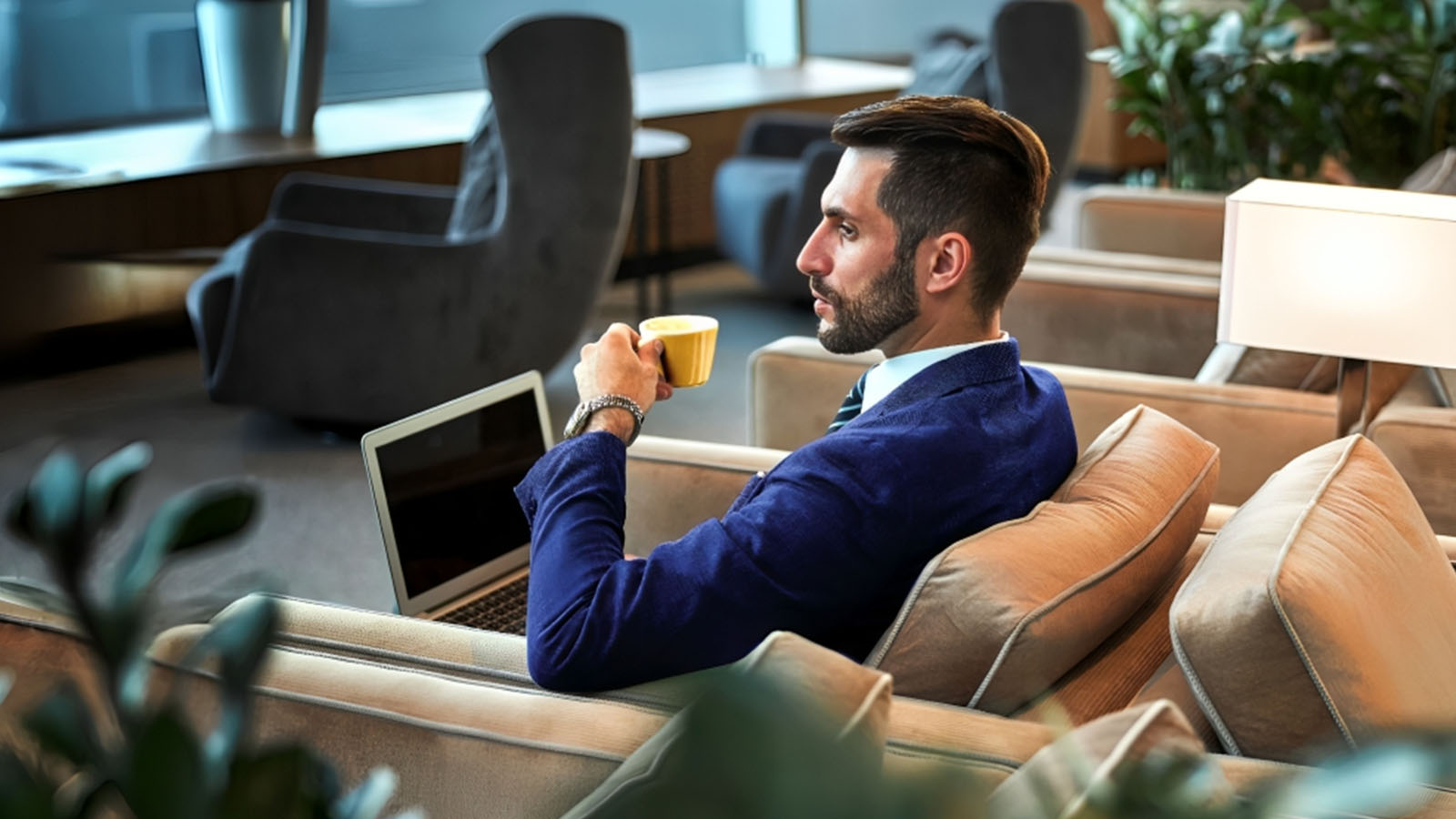 Man waiting at the airport lounge with a laptop